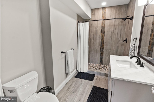 8170 Hollow Rd, Middletown, MD 21769 - bathroom with toilet, vanity, a tile shower, and wood finished floors