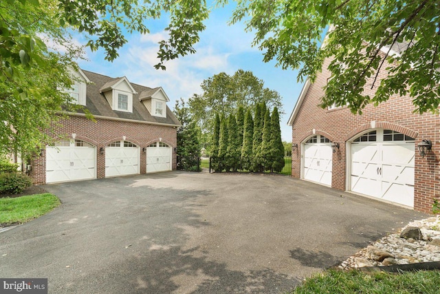 8170 Hollow Rd, Middletown, MD 21769 - view of side of home with brick siding, asphalt driveway, and a garage
