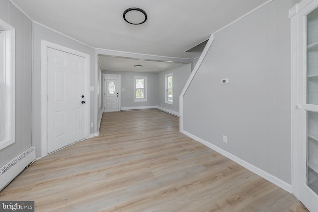 127 N Broad St, Penns Grove, NJ 08069 - foyer featuring a baseboard radiator, wood finished floors, baseboards, and ornamental molding