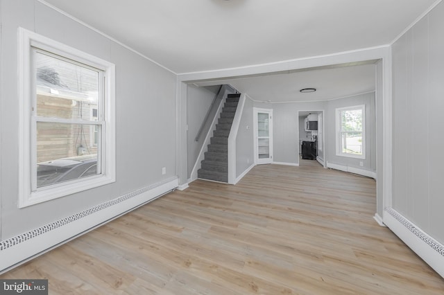 127 N Broad St, Penns Grove, NJ 08069 - unfurnished living room with a baseboard radiator, stairway, ornamental molding, wood finished floors, and baseboards