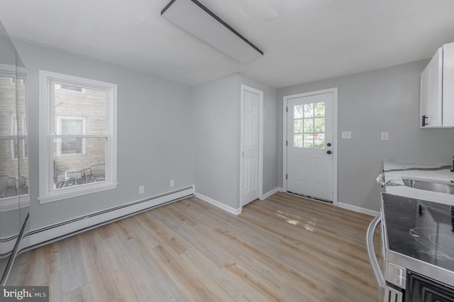 127 N Broad St, Penns Grove, NJ 08069 - clothes washing area featuring baseboard heating, light wood-style flooring, and baseboards