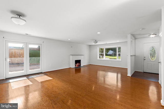 7900 Foote Ln, Springfield, VA 22151 - unfurnished living room featuring wood finished floors, baseboards, recessed lighting, and a brick fireplace