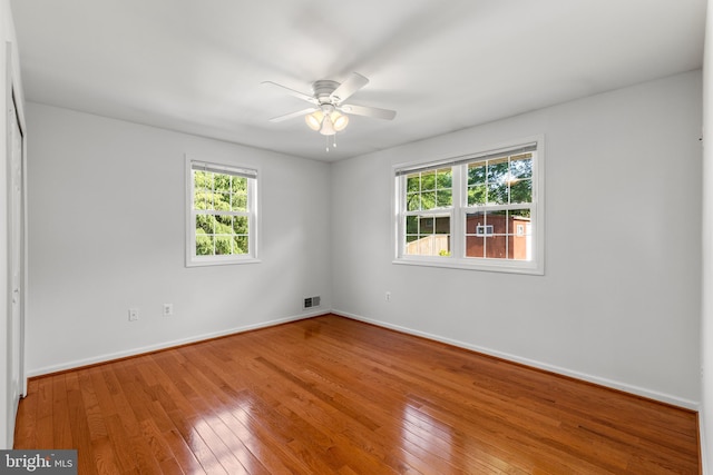 7900 Foote Ln, Springfield, VA 22151 - spare room featuring plenty of natural light, ceiling fan, hardwood / wood-style flooring, and baseboards