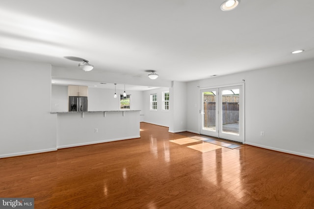 7900 Foote Ln, Springfield, VA 22151 - unfurnished living room featuring baseboards, recessed lighting, and wood finished floors