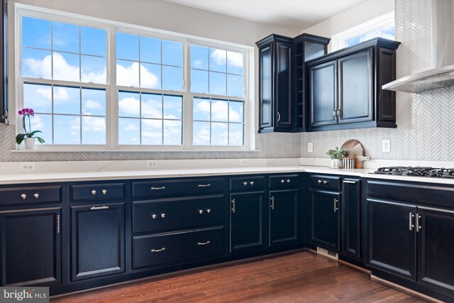 501 Triggerfish Dr, Oxon Hill, MD 20745 - kitchen featuring wall chimney exhaust hood, gas stovetop, healthy amount of natural light, and dark wood finished floors