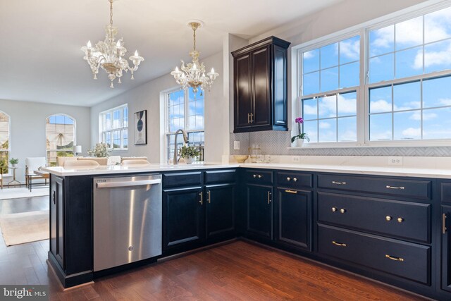501 Triggerfish Dr, Oxon Hill, MD 20745 - kitchen with stainless steel dishwasher, a chandelier, dark wood-type flooring, a peninsula, and light countertops