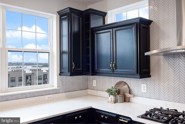 501 Triggerfish Dr, Oxon Hill, MD 20745 - kitchen featuring wall chimney exhaust hood, cooktop, healthy amount of natural light, and tasteful backsplash