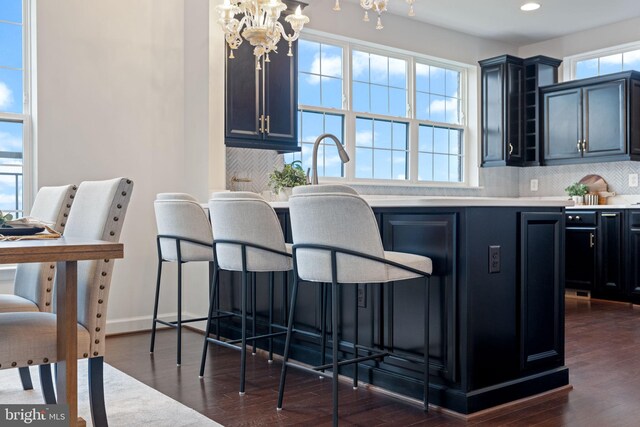 501 Triggerfish Dr, Oxon Hill, MD 20745 - kitchen with a chandelier, backsplash, dark wood-style floors, a kitchen bar, and recessed lighting
