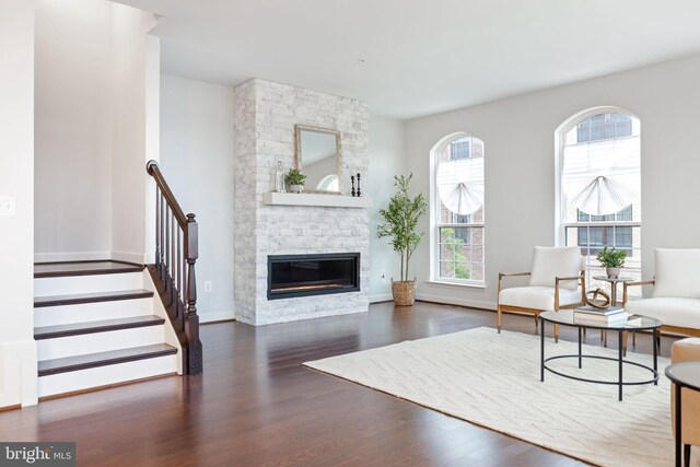 501 Triggerfish Dr, Oxon Hill, MD 20745 - living area featuring wood finished floors, a stone fireplace, baseboards, and stairs