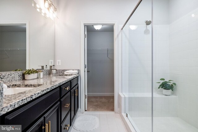 501 Triggerfish Dr, Oxon Hill, MD 20745 - bathroom with a stall shower, double vanity, a spacious closet, and tile patterned flooring