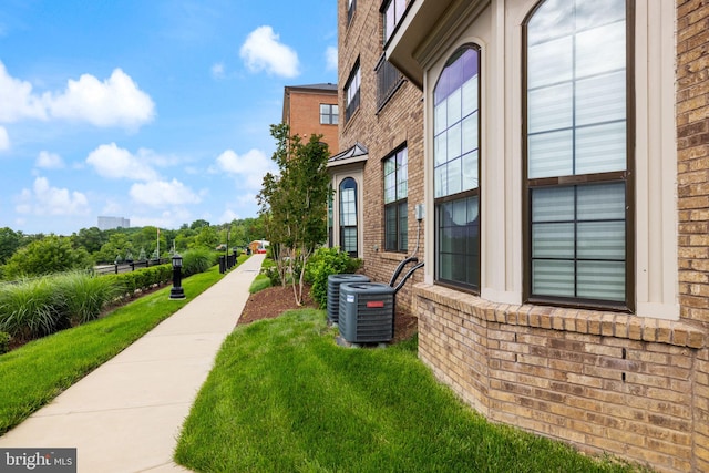 501 Triggerfish Dr, Oxon Hill, MD 20745 - view of home's exterior featuring brick siding, central air condition unit, and a lawn
