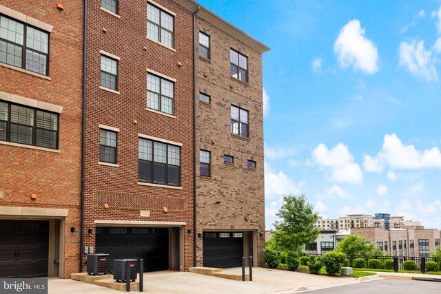 501 Triggerfish Dr, Oxon Hill, MD 20745 - view of property with driveway, an attached garage, and central AC unit