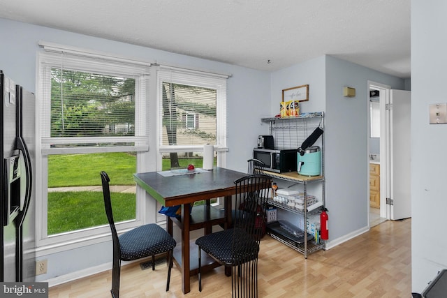 7 Woodland Ct, Hamilton, NJ 08610 - dining room featuring light wood finished floors, baseboards, and a textured ceiling
