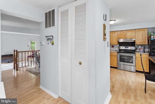 7 Woodland Ct, Hamilton, NJ 08610 - kitchen with stainless steel electric range, light wood-style flooring, under cabinet range hood, baseboards, and light countertops