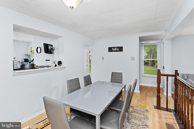 7 Woodland Ct, Hamilton, NJ 08610 - dining space with light wood-style floors, a textured ceiling, and baseboards