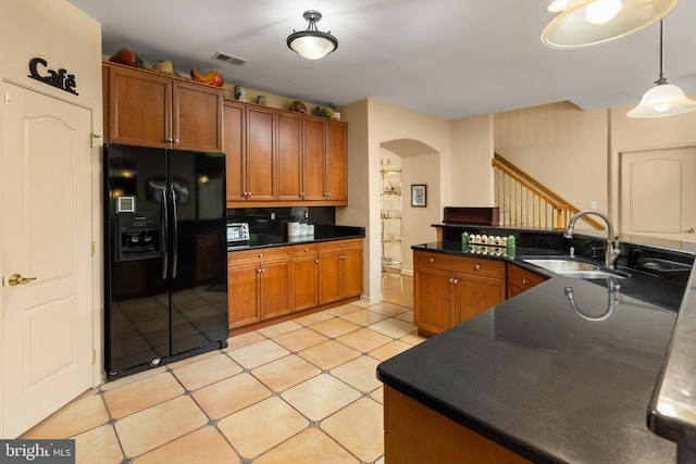 29 Monte Carlo Dr, Hamilton, NJ 08691 - kitchen featuring black refrigerator with ice dispenser, arched walkways, a sink, dark countertops, and brown cabinets