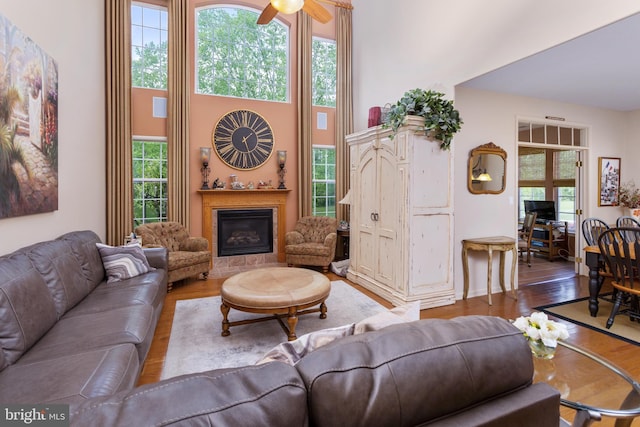29 Monte Carlo Dr, Hamilton, NJ 08691 - living room featuring plenty of natural light, wood finished floors, a glass covered fireplace, and a high ceiling