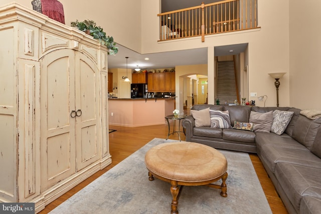 29 Monte Carlo Dr, Hamilton, NJ 08691 - living room featuring wood finished floors, arched walkways, a high ceiling, and baseboards