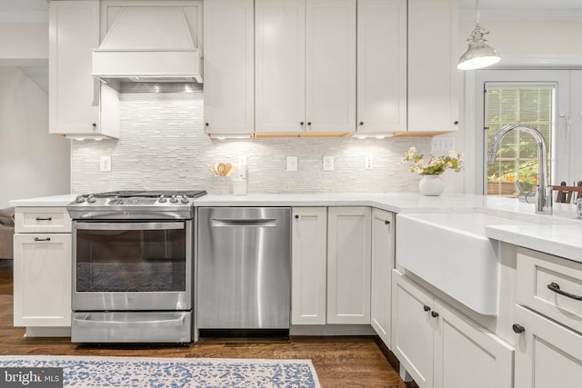255 Lower Magothy Beach Rd, Severna Park, MD 21146 - kitchen with custom range hood, appliances with stainless steel finishes, a sink, crown molding, and dark wood finished floors