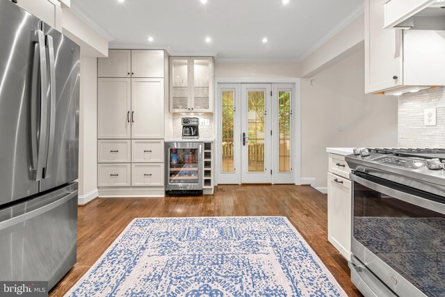255 Lower Magothy Beach Rd, Severna Park, MD 21146 - kitchen with stainless steel appliances, beverage cooler, dark wood-type flooring, tasteful backsplash, and crown molding