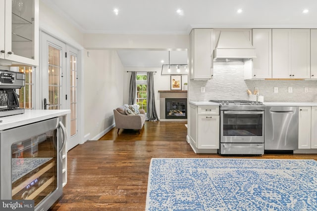 255 Lower Magothy Beach Rd, Severna Park, MD 21146 - kitchen with appliances with stainless steel finishes, wine cooler, custom exhaust hood, light countertops, and ornamental molding