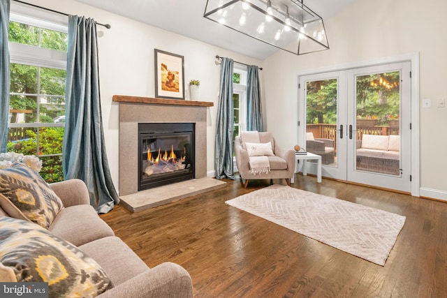 255 Lower Magothy Beach Rd, Severna Park, MD 21146 - living room with vaulted ceiling, a glass covered fireplace, wood finished floors, french doors, and baseboards