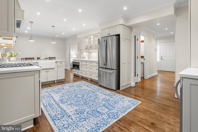 255 Lower Magothy Beach Rd, Severna Park, MD 21146 - kitchen with appliances with stainless steel finishes, a sink, light countertops, ornamental molding, and glass insert cabinets