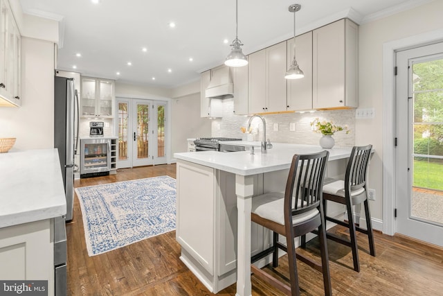 255 Lower Magothy Beach Rd, Severna Park, MD 21146 - kitchen with wine cooler, custom exhaust hood, stainless steel appliances, a peninsula, and a sink