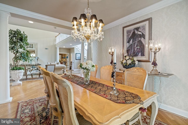 dining room with a chandelier, ornamental molding, wood finished floors, and baseboards
