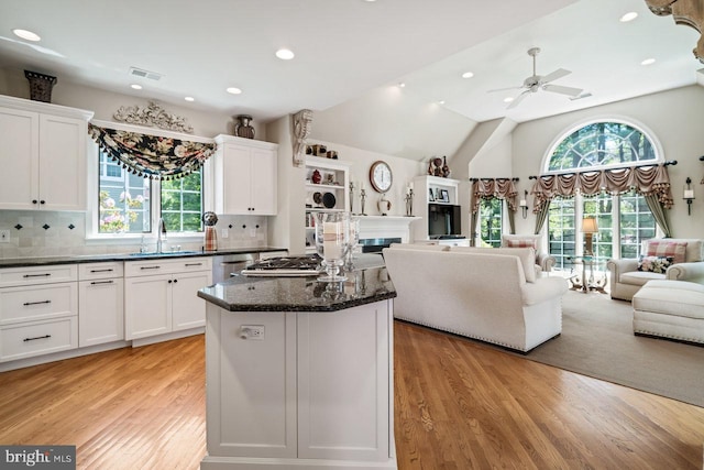 kitchen with a sink, light wood-type flooring, open floor plan, healthy amount of natural light, and recessed lighting