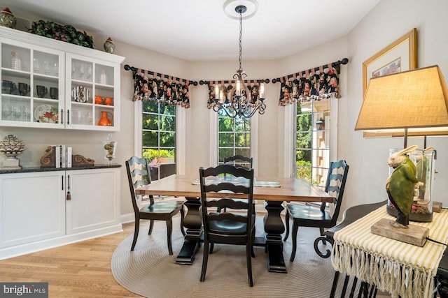 dining area featuring a chandelier and light wood-style flooring
