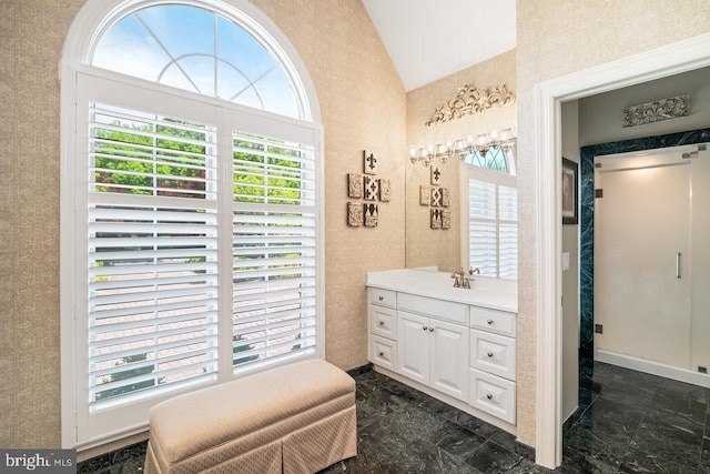 bathroom with lofted ceiling and vanity