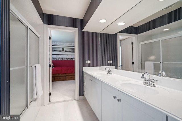 bathroom with an enclosed shower, double vanity, recessed lighting, and tile patterned floors