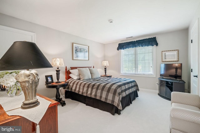 carpeted bedroom with baseboards