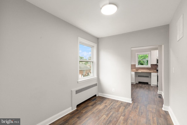 2811 Westfield Ave, Baltimore, MD 21214 - spare room with radiator heating unit and dark wood-style floors