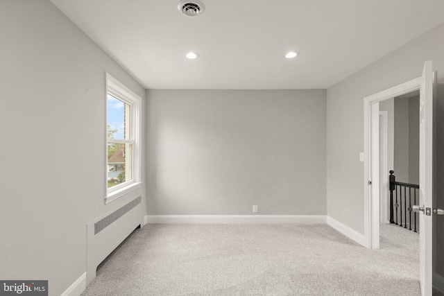 2811 Westfield Ave, Baltimore, MD 21214 - empty room featuring radiator, light colored carpet, and recessed lighting