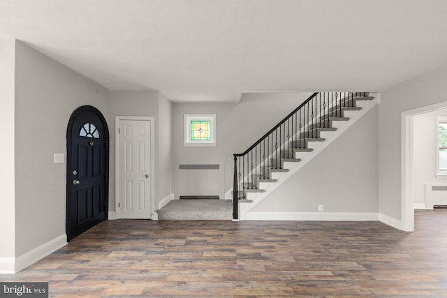 2811 Westfield Ave, Baltimore, MD 21214 - foyer entrance featuring wood finished floors, stairs, and radiator heating unit