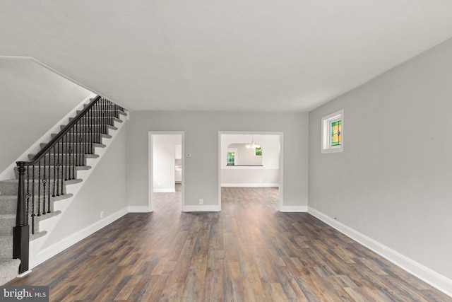 2811 Westfield Ave, Baltimore, MD 21214 - unfurnished living room with dark wood-type flooring and stairs
