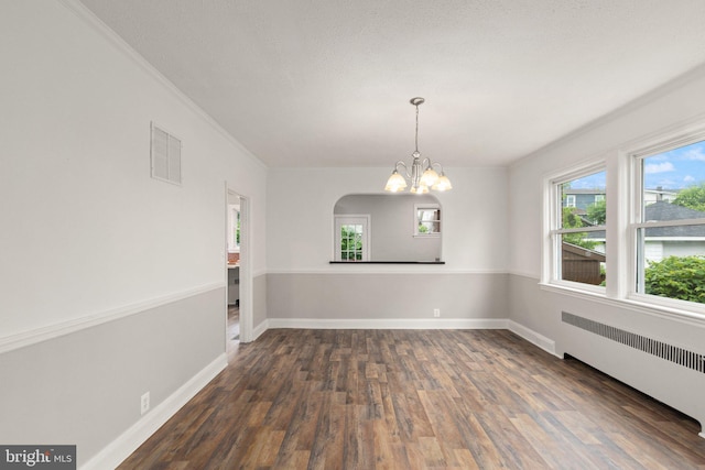 2811 Westfield Ave, Baltimore, MD 21214 - unfurnished room featuring radiator, a chandelier, dark wood-type flooring, and crown molding