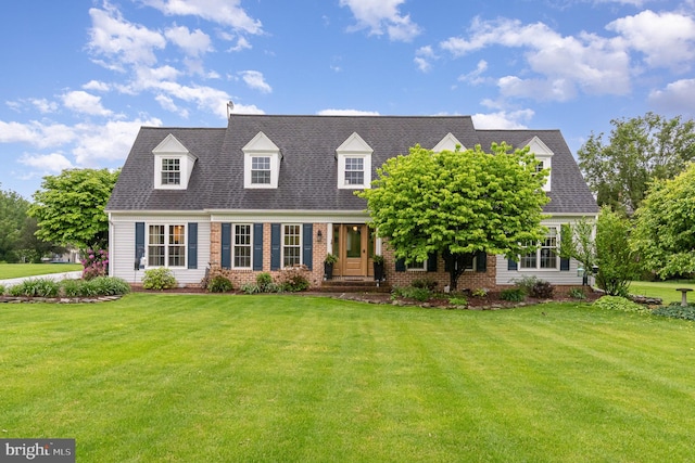 cape cod house with a front lawn and brick siding