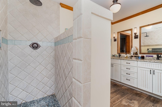 full bath featuring a walk in shower, double vanity, ornamental molding, and wood finished floors