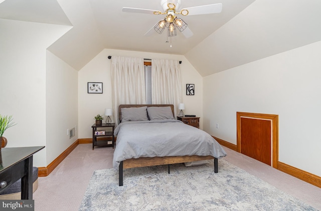 bedroom featuring light carpet, baseboards, lofted ceiling, and ceiling fan
