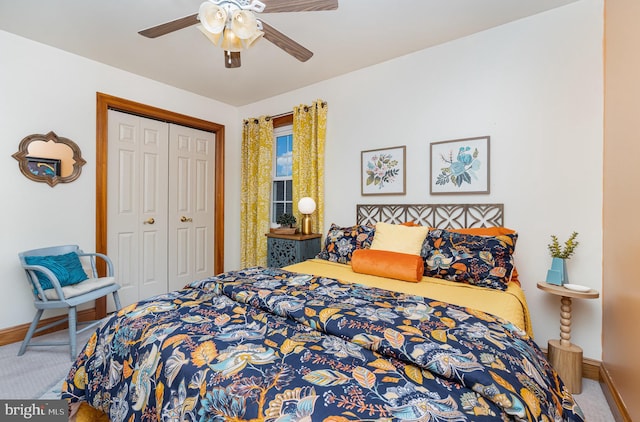 carpeted bedroom with baseboards, a closet, and ceiling fan
