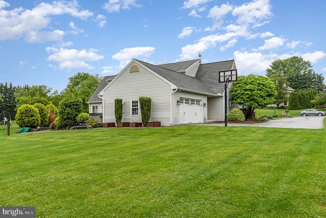 view of property exterior with a garage, a yard, a shingled roof, and asphalt driveway