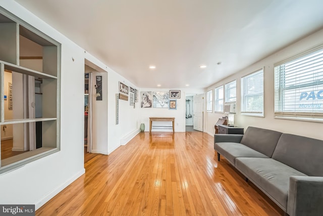 living room with light wood-style floors, baseboards, and recessed lighting