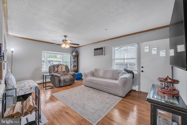 living area with a baseboard heating unit, crown molding, a textured ceiling, a wall mounted air conditioner, and light wood-type flooring