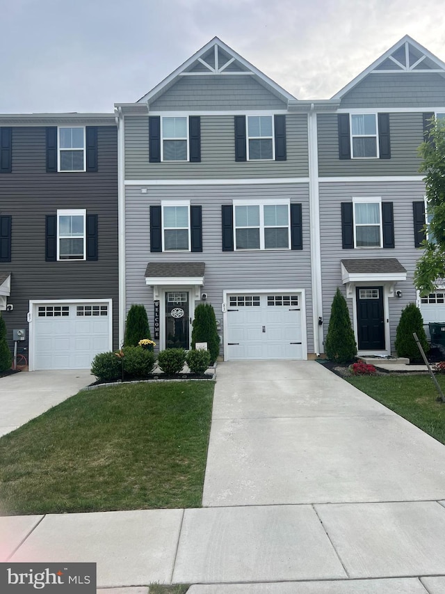 townhome / multi-family property featuring driveway, a garage, and a front lawn