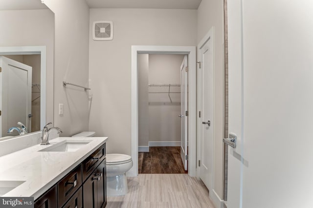 1761 Old Meadow Rd Unit 209, Mclean, VA 22102 - bathroom with toilet, double vanity, a walk in closet, and baseboards