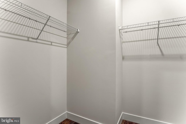1761 Old Meadow Rd Unit 209, Mclean, VA 22102 - spacious closet featuring dark wood-type flooring