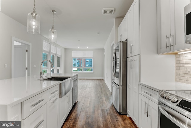 1761 Old Meadow Rd Unit 209, Mclean, VA 22102 - kitchen with stainless steel appliances, a sink, dark wood finished floors, white cabinets, and recessed lighting